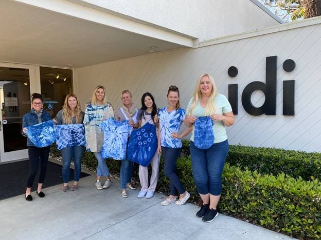 idi students show off one of their projects from our Textiles class