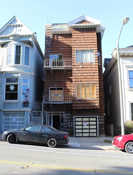 Victorian home exterior with brown cedar shingles before renovation