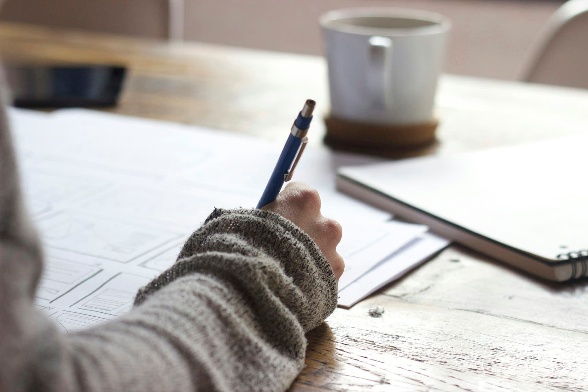 Student studying with financial documents and laptop